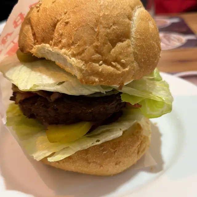 Burger z wołowiną, sałatą i serem w bułce z sezamem